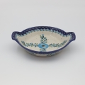 Round baking dish with handles made of Boleslawiec pottery.