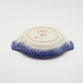 Hand decorated round baking dish with handles made from authentic Boleslawiec pottery.