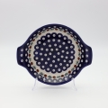 Round baking dish with handles made of Boleslawiec pottery.
