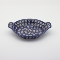 Round baking dish with handles made of Boleslawiec pottery.