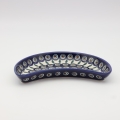 Unique Bolesławiec tray in crescent shape, perfect for serving snacks.