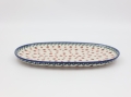 Detail of hand-painted decoration on Boleslawiec ceramic platter – traditional Polish pottery.