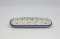 Boleslawiec rectangular ceramic platter CH on table – traditional Polish serving dish.