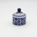 Boleslawiec ceramic sugar bowl with lid on table – traditional Polish tableware.